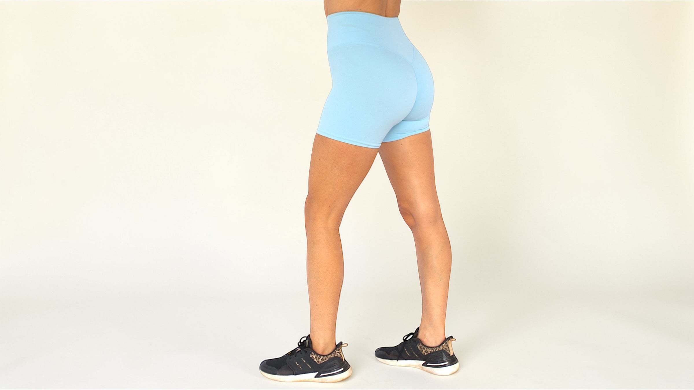Person wearing light blue athletic shorts on a plain background