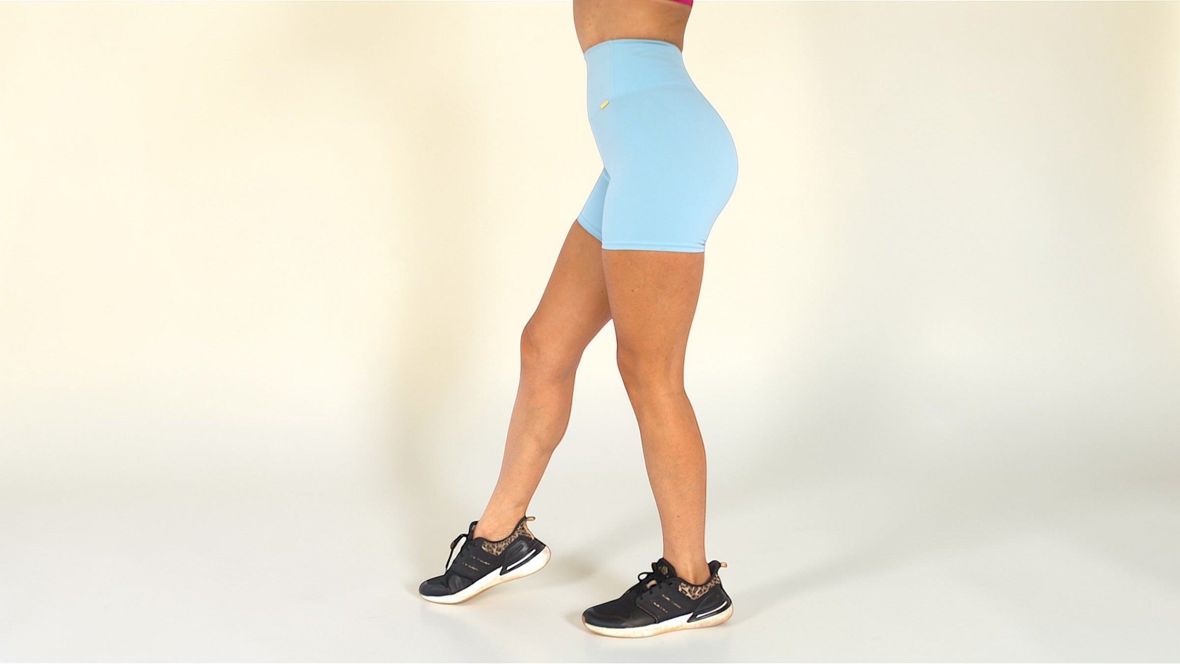 Person wearing light blue athletic shorts on a plain background